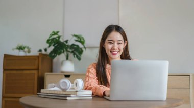 Yerlerde oturan ve iş verilerini bilgisayarda evde yaşam tarzında yazan kadınlar..