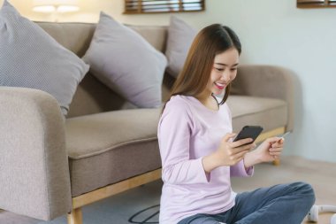 Kadınlar internet üzerinden alışveriş yaparken akıllı telefon ve kredi kartı kullanırlar..