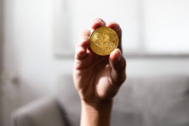 İnsanoğlunun eli, gelecekte sanal elektronik parayla yaşayabilmek için altın kripto para taşır..