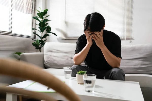 stock image Man using both hands to covering faces with emotional of stressed and depressed in mental health.