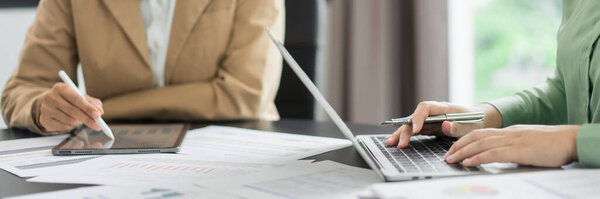 Alternative energy environment businesspeople read data to discuss about renewable energy together.