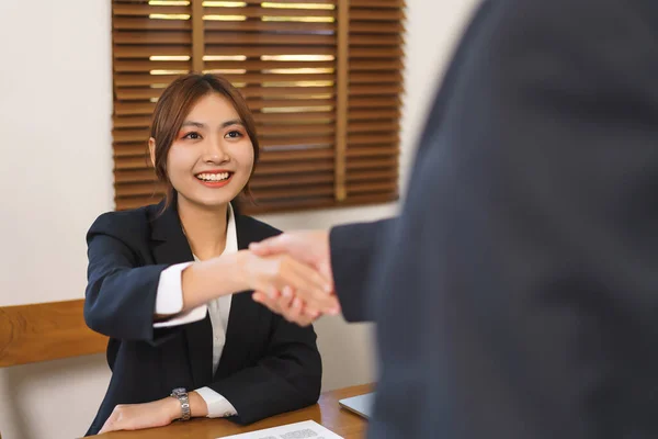 Business analysis concept, Businesswoman and senior business shaking hand after deal work together.