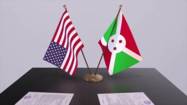 Burundi ve ABD müzakere masasında, diplomatik bir anlaşma. İş ve politika animasyonu. Ulusal bayraklar, diplomasi anlaşması. Kağıt belgeler masanın üstünde. Uluslararası anlaşma