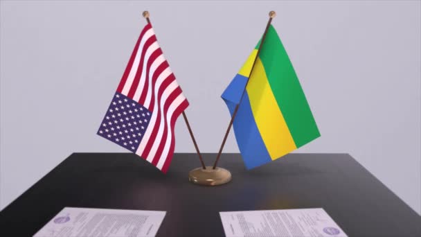 ガボンと米国は交渉の場で外交協定を結んだ ビジネスと政治のアニメーション 国旗外交協定だ 机の上の書類 国際協定 — ストック動画