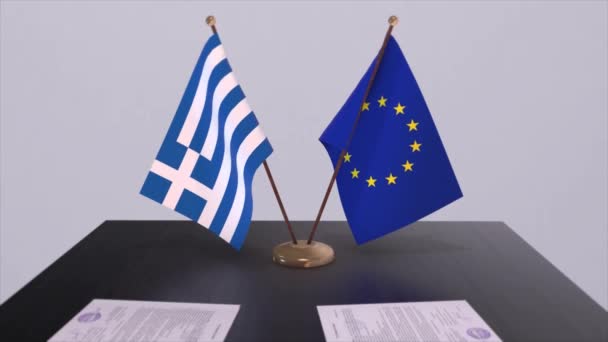 テーブルの上にギリシャとEuの旗 国との政治取引またはビジネス契約3Dアニメーション — ストック動画