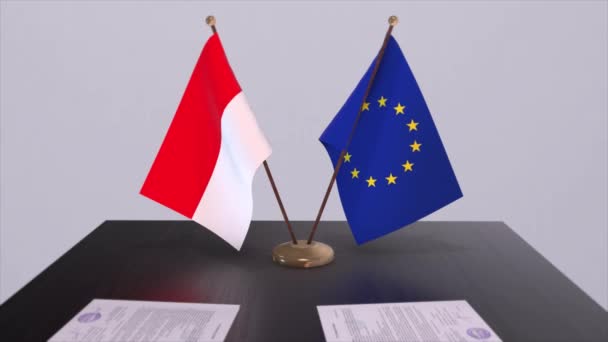 テーブルの上にインドネシアとEuの旗 国との政治取引またはビジネス契約3Dアニメーション — ストック動画