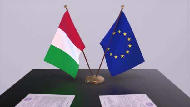 テーブルの上にイタリアとEuの旗 国との政治取引またはビジネス契約3Dアニメーション — ストック動画