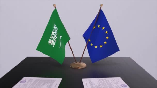 サウジアラビアとEuはテーブルの上にフラグを立てます 国との政治取引またはビジネス契約3Dアニメーション — ストック動画