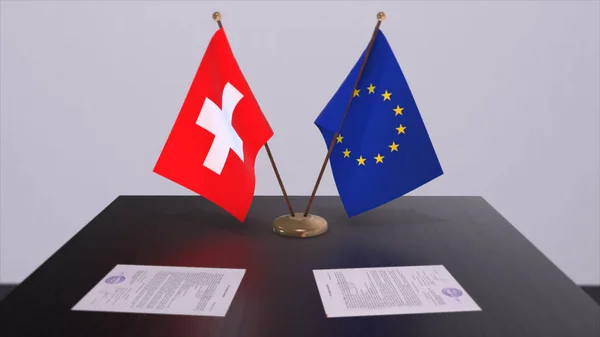 stock image Switzerland and EU flag on table. Politics deal or business agreement with country 3D illustration.