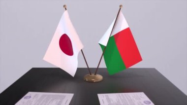 Madagaskar ve Japonya ulusal bayrakları, politik anlaşma, diplomatik toplantı. Politika ve iş animasyonu