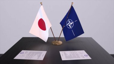 London, UK - 15 February 2023: Japan country national flag and NATO flag. Politics and diplomacy illustration, Illustrative Editorial.