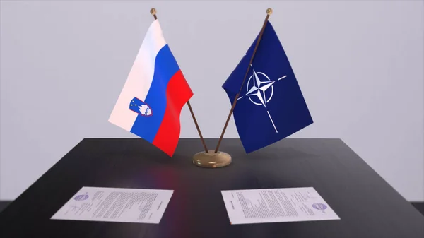 stock image London, UK - 15 February 2023: Slovenia country national flag and NATO flag. Politics and diplomacy illustration, Illustrative Editorial.