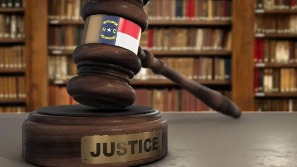 stock image North Carolina State Flag on Judge Hammer in Court with Word Justice. Justice System 3D Illustration.