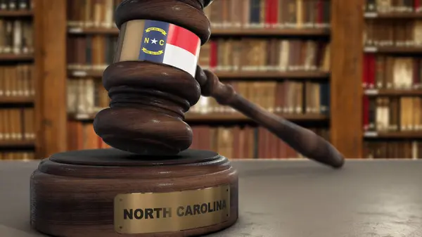 Stock image North Carolina Flag on Judge Gavel or Hammer in Court with State Name. Legal System 3D Illustration.