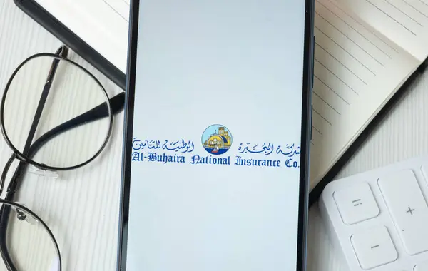 stock image New York, USA - 21 June 2024: Al Buhaira National Insurance Logo on Phone Screen, Company Icon.