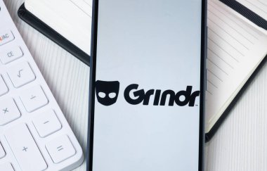 New York, USA - 30 June 2024: Grindr Logo on Phone Screen, Company Icon. clipart