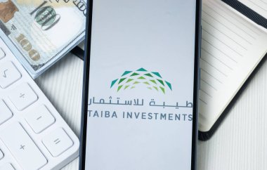 New York, USA - 30 June 2024: Taiba Investments Logo on Phone Screen, Company Icon. clipart