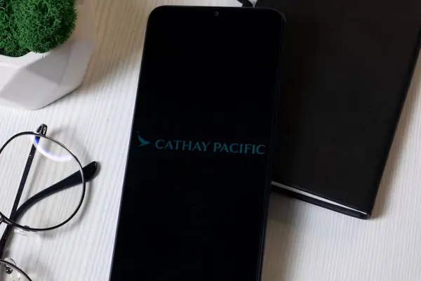 stock image New York, USA - 1 June 2024: Cathay Pacific Airways Logo on Phone Screen, Company Icon.