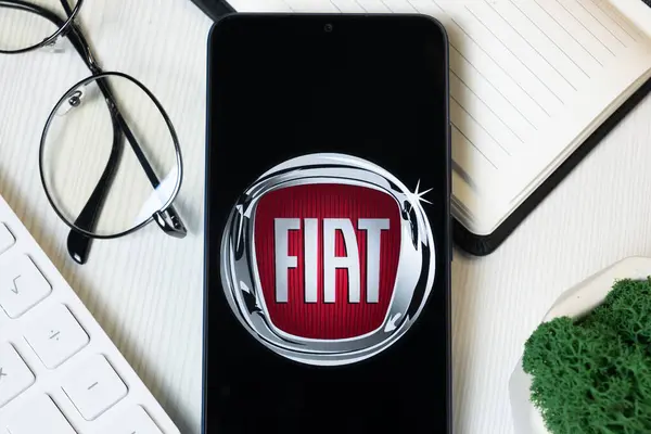 stock image New York, USA - 1 June 2024: Fiat Chrysler Automobiles Logo on Phone Screen, Company Icon.