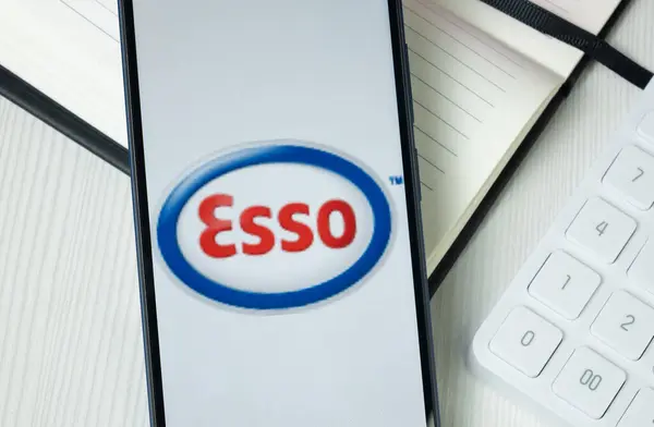 stock image New York, USA - 30 June 2024: Esso Logo on Phone Screen, Company Icon.