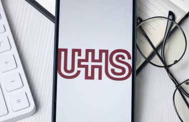 New York, USA - 21 June 2024: Universal Health Services Logo on Phone Screen, UHS Company Icon. clipart