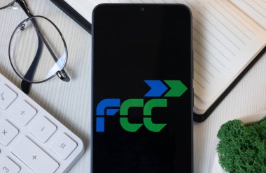 New York, USA - 11 June 2024: FCC Logo on Phone Screen, Fomento de Construcciones y Contratas Company Icon. clipart