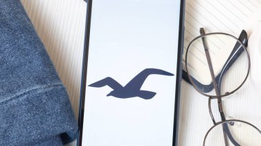 New York, USA - 21 June 2024: Hollister Logo on Phone Screen, Company Icon. clipart