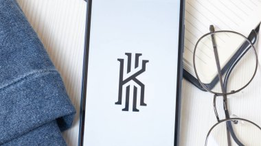 New York, USA - 21 June 2024: Kyrie Irving Logo on Phone Screen, Company Icon. clipart