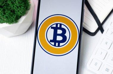 New York, USA - 1 August 2024: Bitcoin Gold BTG Logo on Phone Screen, Crypto Coin Icon. clipart