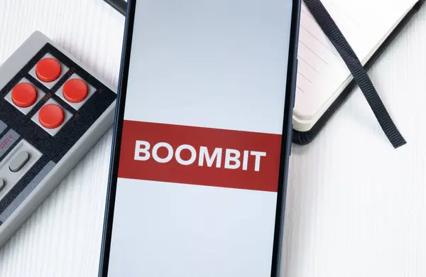 stock image New York, USA - 1 August 2024: BoomBit Logo on Phone Screen, Company Icon on Display.