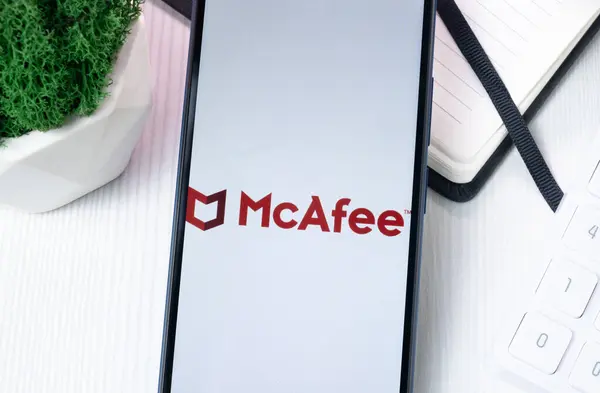 stock image New York, USA - 10 August 2024: McAfee Logo on Phone Screen, Company Icon on Display.