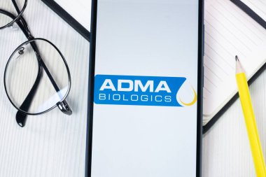 New York, USA - 1 August 2024: ADMA Biologics Logo on Phone Screen, Company Icon on Display. clipart