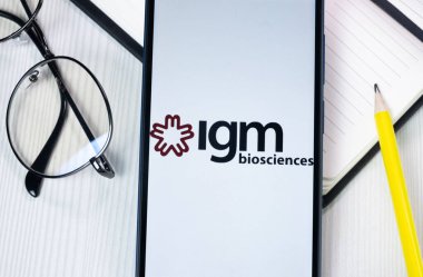 New York, USA - 1 August 2024: IGM Biosciences Logo on Phone Screen, Company Icon on Display. clipart