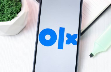 New York, USA - 1 August 2024: OLX Logo on Phone Screen, Icon on Display. clipart