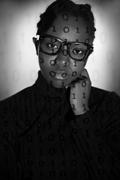 Black and white portrait of a young black female with cyber security issues. One and zeros from projection light.