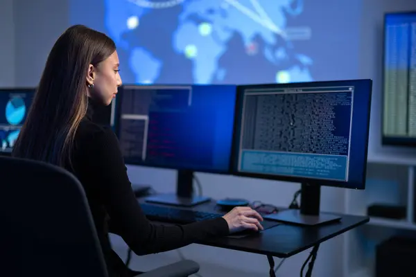 stock image Busy professional female IT consultant together with a cyber security team working to prevent security threats, find vulnerability and solve incidents. Woman pointing on a event map.