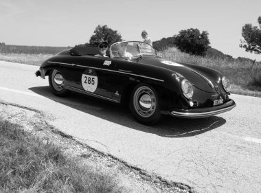 URBINO, ITALY - JUN 16 - 2022 : PORSCHE 356 1500 SPEEDSTER 1955 on an old racing car in rally Mille Miglia 2022 the famous italian historical race