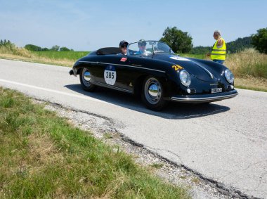 URBINO, ITALY - JUN 16 - 2022 : PORSCHE 356 1500 SPEEDSTER 1955 on an old racing car in rally Mille Miglia 2022 the famous italian historical race