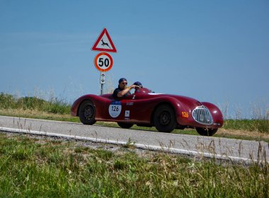 URBINO, ITALY - JUN 16 - 2022 : LANCIA APRILIA SPORT 1946 on an old racing car in rally Mille Miglia 2022 the famous italian historical race