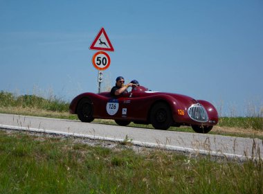 URBINO, ITALY - JUN 16 - 2022 : LANCIA APRILIA SPORT 1946 on an old racing car in rally Mille Miglia 2022 the famous italian historical race
