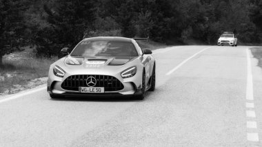 URBINO - ITALY - JUN 16 - 2022 : Mercedes AMG GT Coupe on an old racing car in rally Mille Miglia 2022 the famous italian historical race