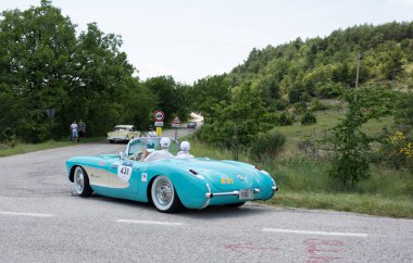 URBINO - ITALY - JUN 16 - 2022 : CHEVROLET CORVETTE 1957 on an old racing car in rally Mille Miglia 2022 the famous italian historical race