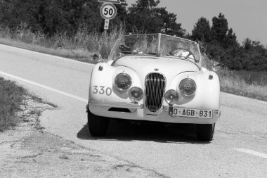 URBINO - ITALY - JUN 16 - 2022 : JAGUAR XK120 OTS SE ROADSTER 1954 on an old racing car in rally Mille Miglia 2022 the famous italian historical race