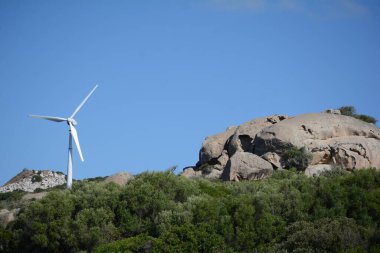 Wind turbines against the blue Sardinian sky, harnessing Mediterranean winds for a sustainable future clipart