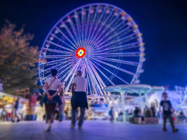 People Enjoying Night Amusement Park Stock Photo
