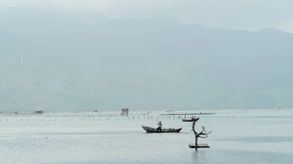 stock image Fisherman in a boat on the river background. High quality photo