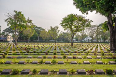 KANCHANABURI,THAILAND - JANUARY 27,2023 - View at the War Cemetery in Kanchanaburi.  Kanchanaburi lies 123 km west of Bangkok.