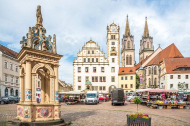 OSCHATZ,GERMANY - JULY 16,2024 - View at the Town hall building and Saint Aegidius church at Marketplace of Oschatz. Oschatz is a town in the district Nordsachsen, in Saxony, Germany. clipart