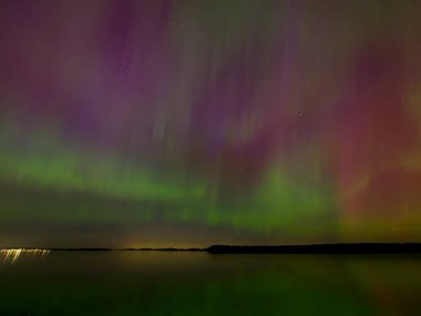 Aurora Borealis illuminates the sky over Central Saanich, BC in rare intensive solar activity clipart