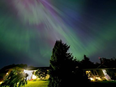 Aurora Borealis illuminates the sky over Central Saanich, BC in rare intensive solar activity clipart